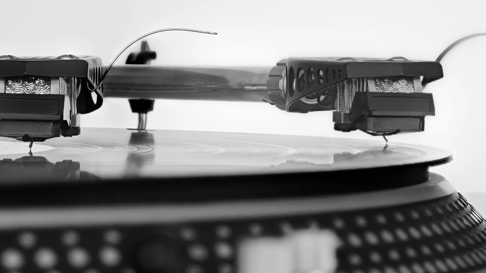 Extreme macro photograph of a phonograph needle tracing a vinyl record's groove